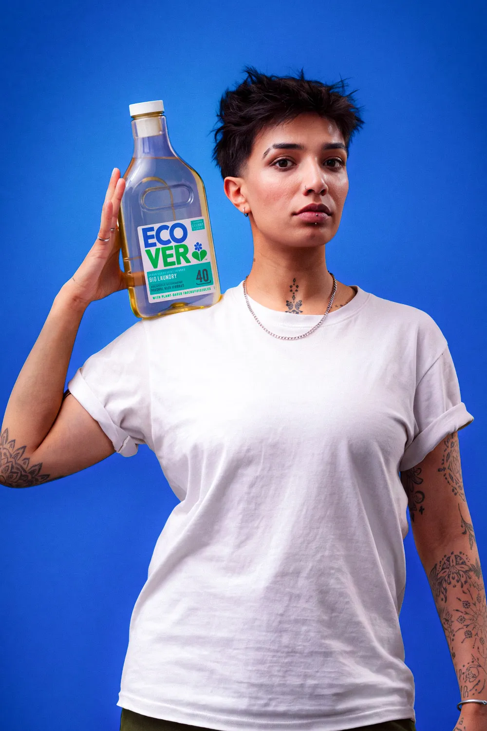 Model holding an Ecover laundry bottle against a blue backdrop